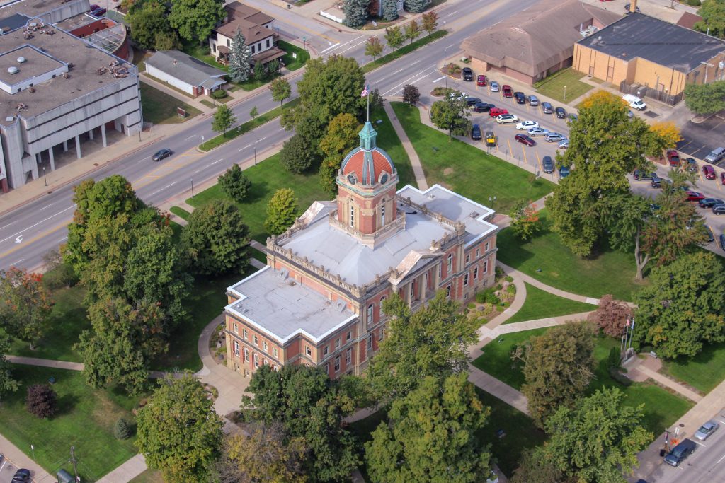 Aerial view of the Elkhart County courthouse, surrounded by trees.