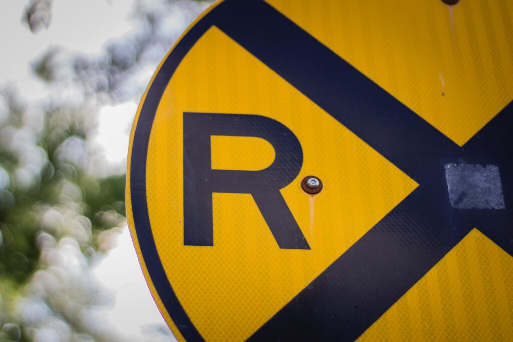 Up close photo of a yellow railroad crossing sign