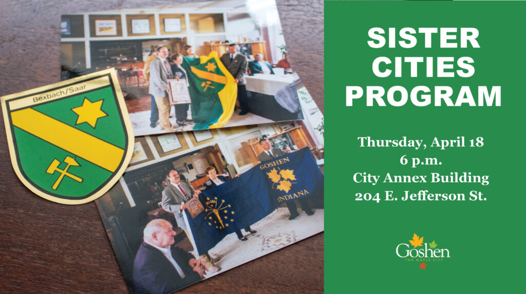 Bexbach coat of arms and two photos of people with flags of Bexbach and Goshen. Text on right says: "Sister Cities Program, Thursday, April 18, 6 p.m., City Annex Building, 204 E. Jefferson St."